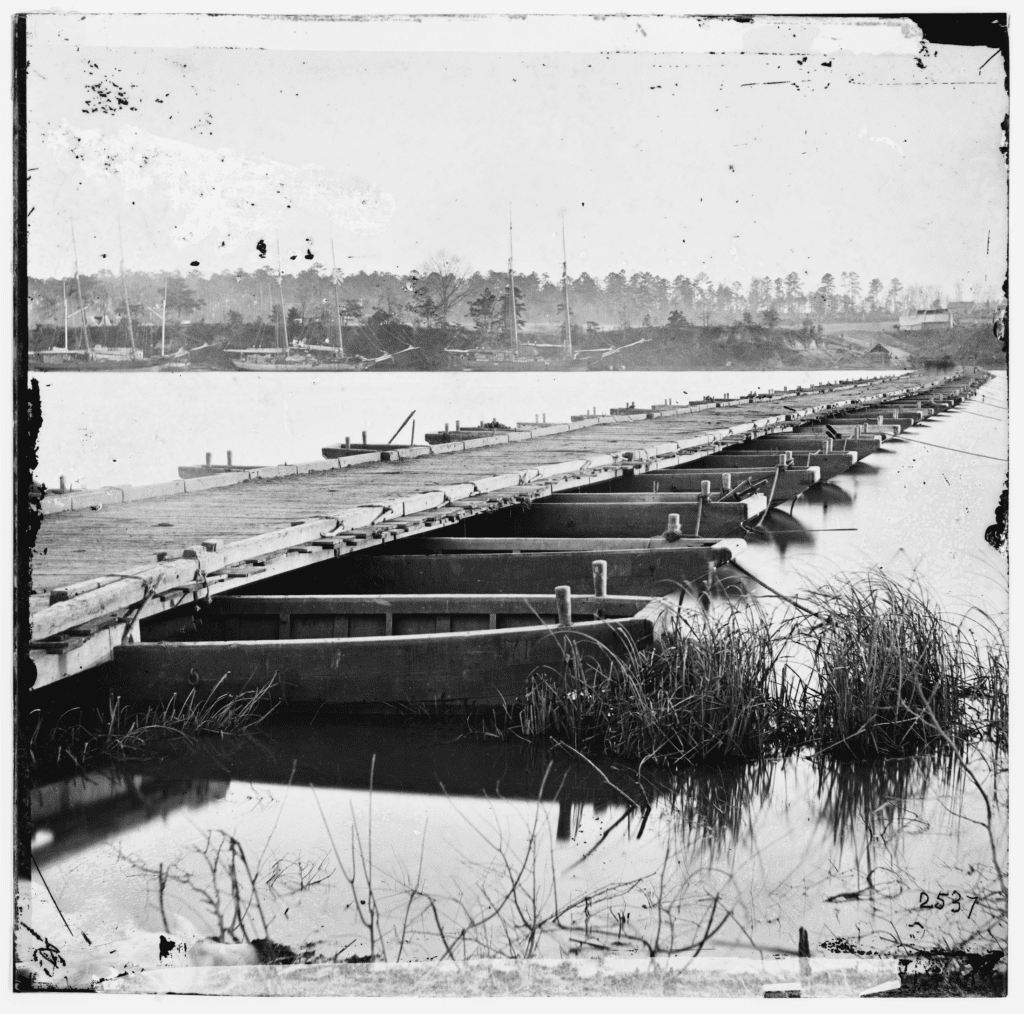 Historic black and white image of bridge supported by pontoons over the James River