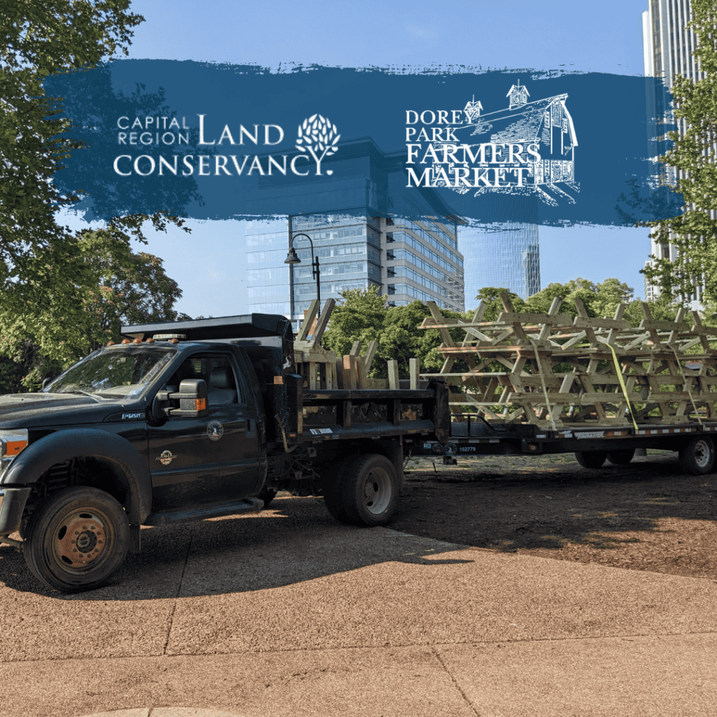 Graphic reading Capital Region Land Conservancy and Dorey Park overlay image of truck loaded with picknice tables and benches