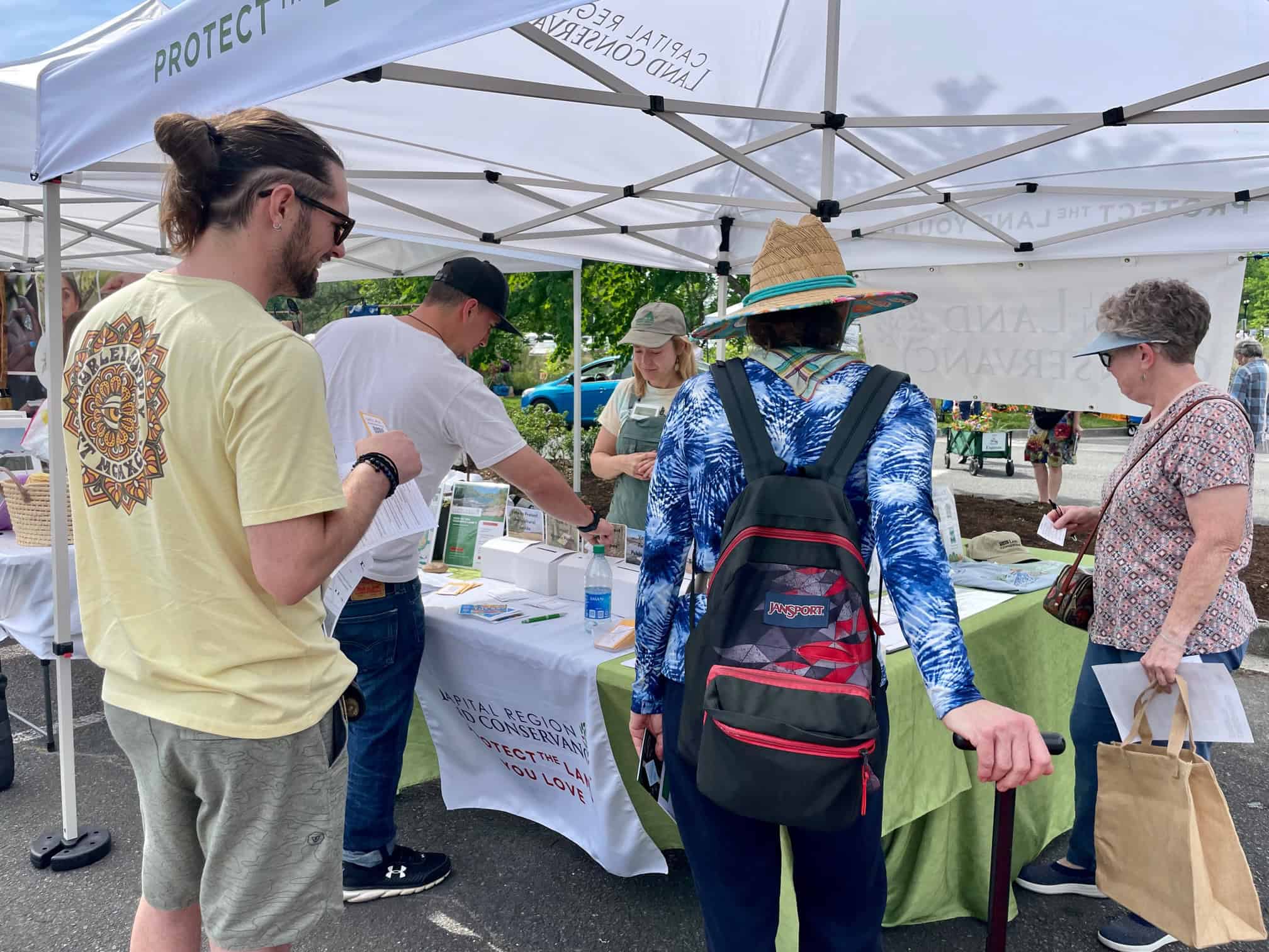 Visitors stop at Capital Region Land Conservancy tent during Lewis Ginter Botanical Garden Plant Sale