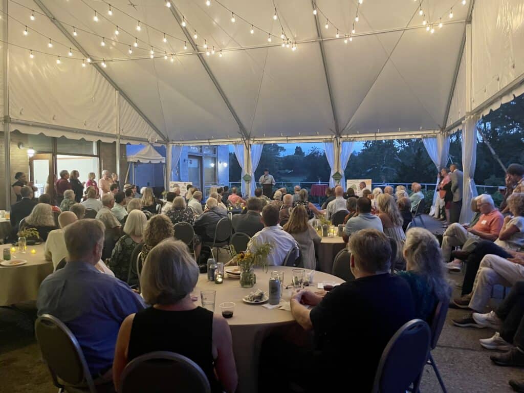 Guests gather under a large tent at Maymont for CRLC's annual Fields, Forests & Streams fundraiser