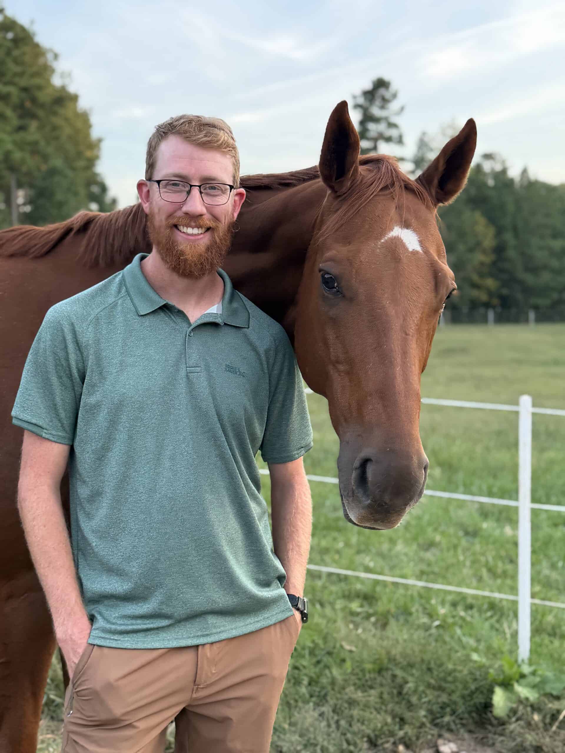 Connor Almond stands by his horse on his farm in Amelia County