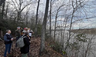 A group of hikers look out over the James River