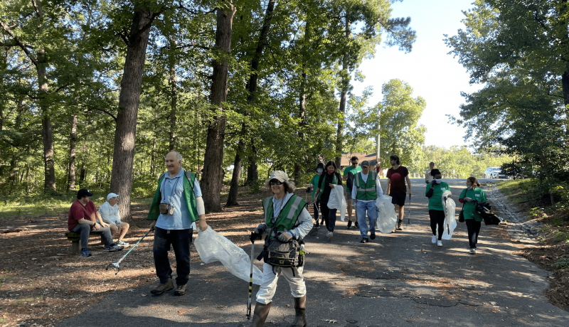 Group of volunteers walks to the creek at Bryan Park for the Team Streams Clean-Up event.